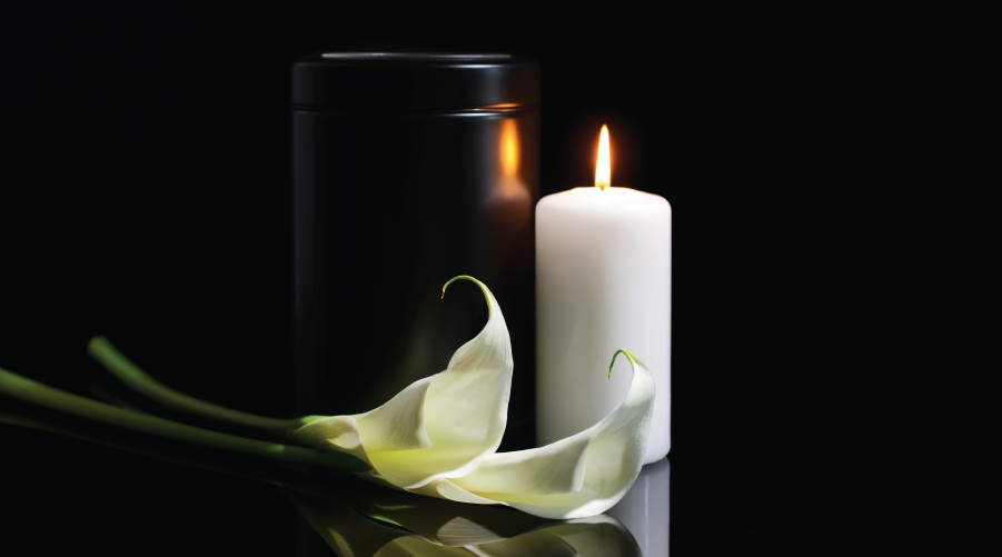 En imagen una vela y una flor y fondo negro. Utilizada para una esquela.